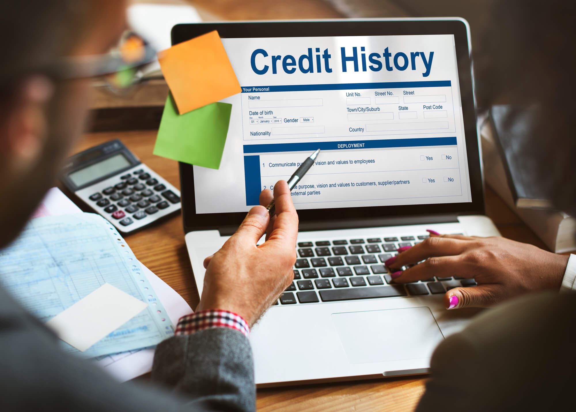 A financial counselor gives free credit counseling while reviewing a client's credit history